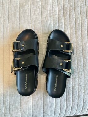 BCBGeneration Black Slide Sandals with Gold Buckles